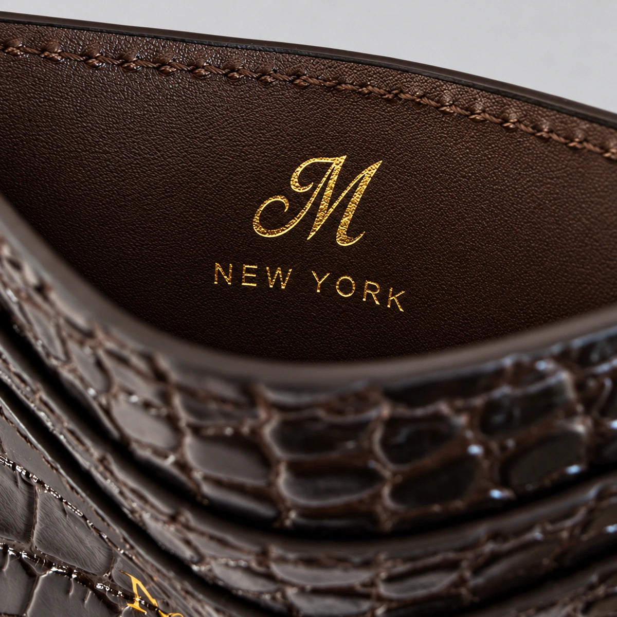 M and NEW YORK inscription inside the stitched central cash compartment.