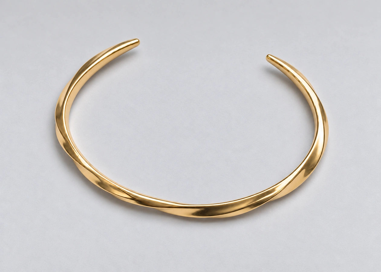 Open gold cuff with both tapered ends visible.