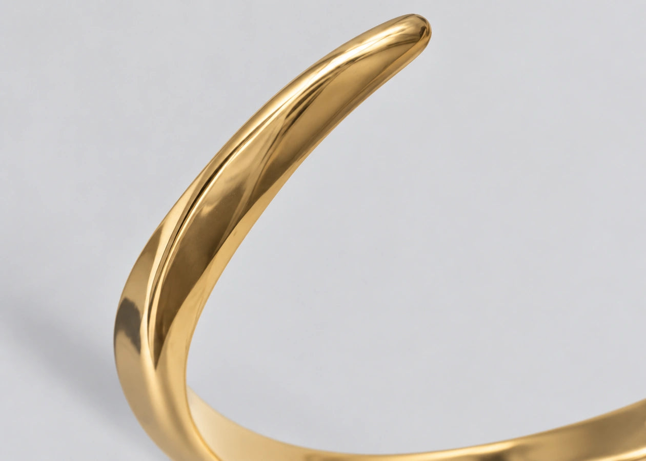Close-up of the polished gold-plated cuff surface.