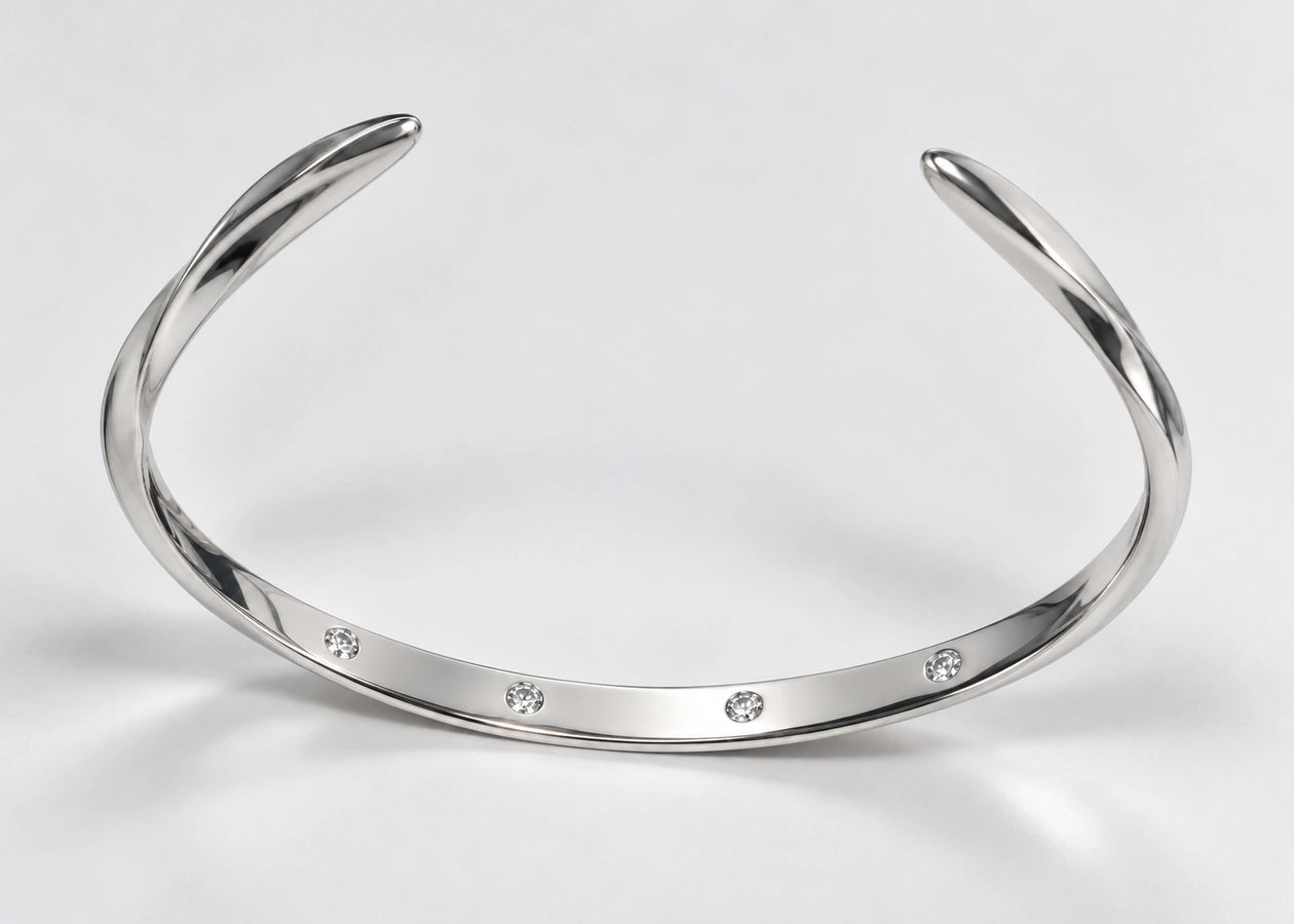 Open silver cuff with both tapered ends visible.