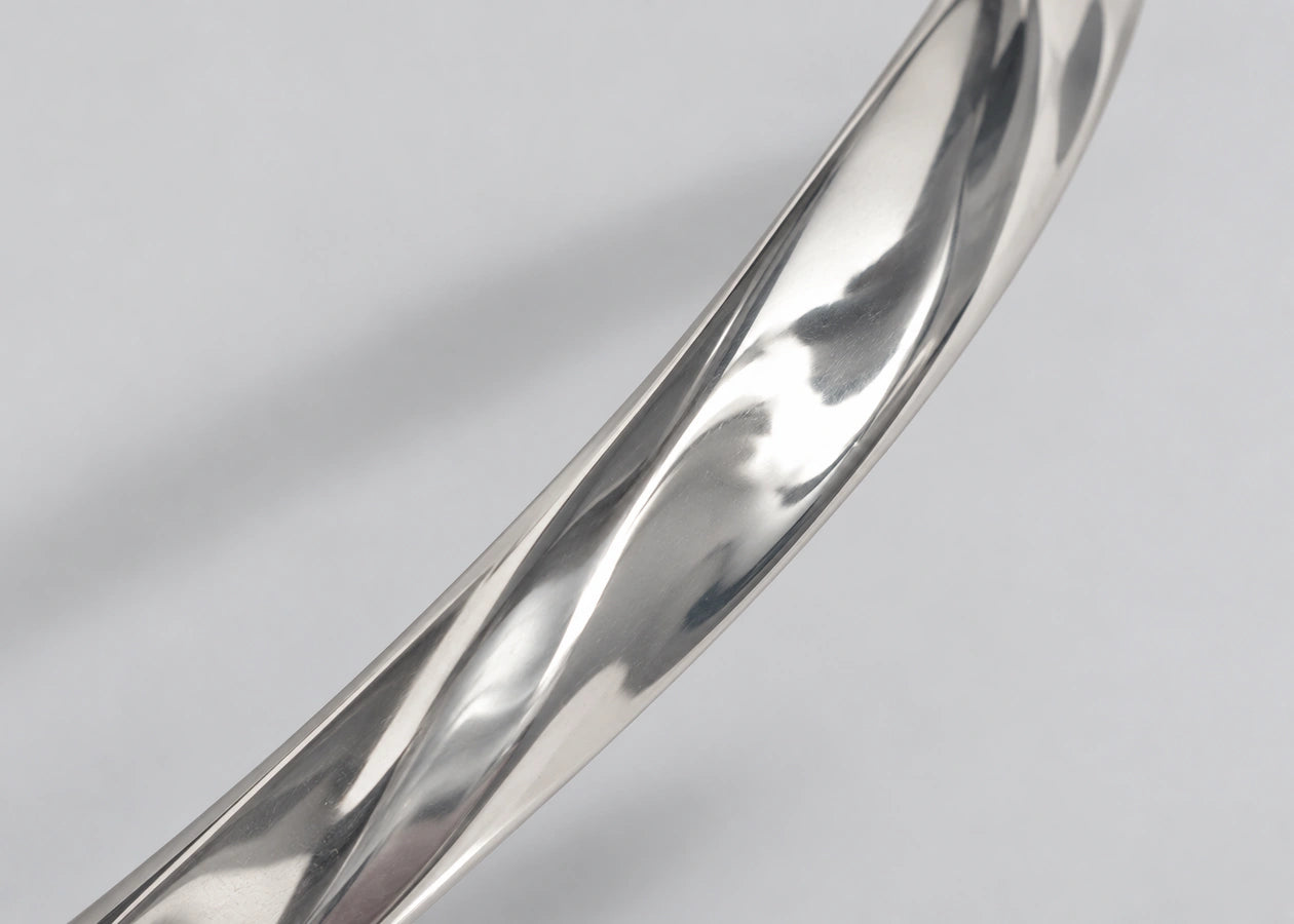 Close-up of the polished rhodium-plated cuff surface.